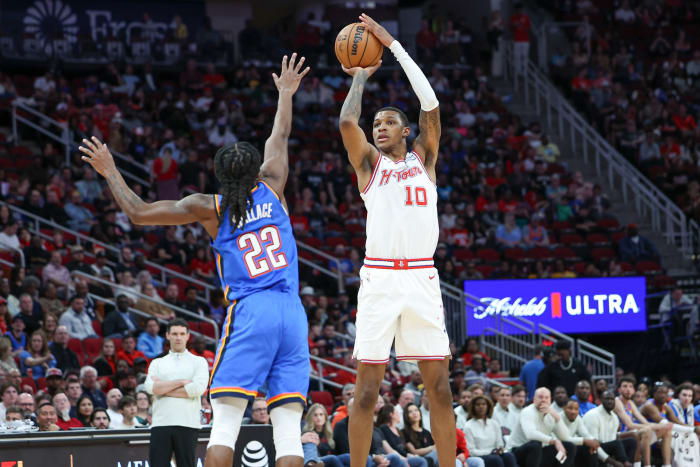 Rockets forward Jabari Smith Jr. (10) shoots the ball over Oklahoma City Thunder guard Cason Wallace (22) during the first quarter at Toyota Center.